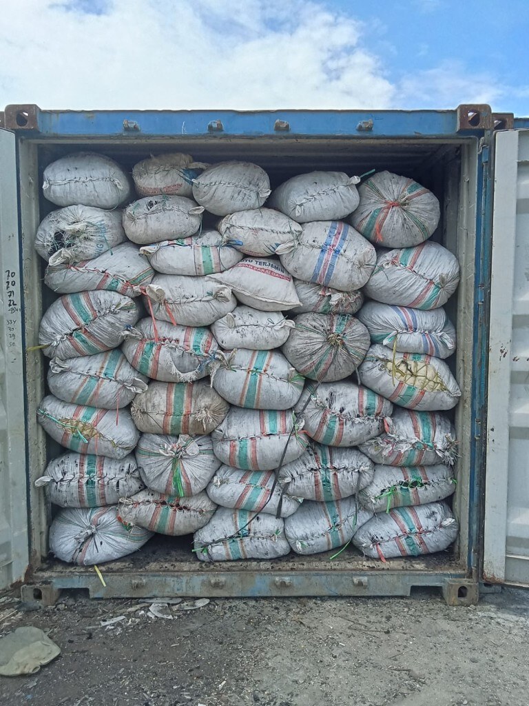 Open blue shipping container filled floor to ceiling with export sacks