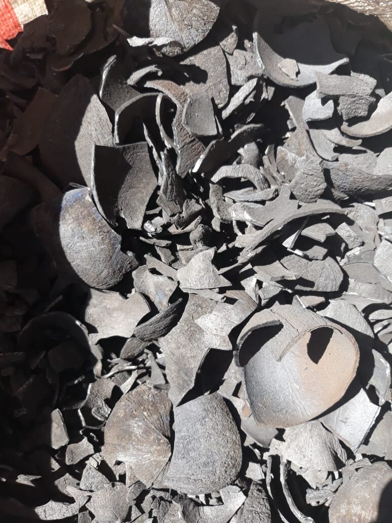 Bulk charcoal pile with woven sack